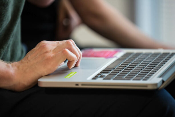 A person using the trackpad on a laptop