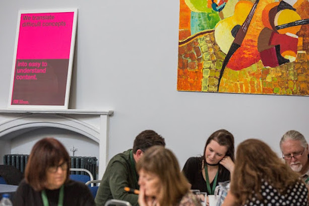 A group of people sitting at a table during an event